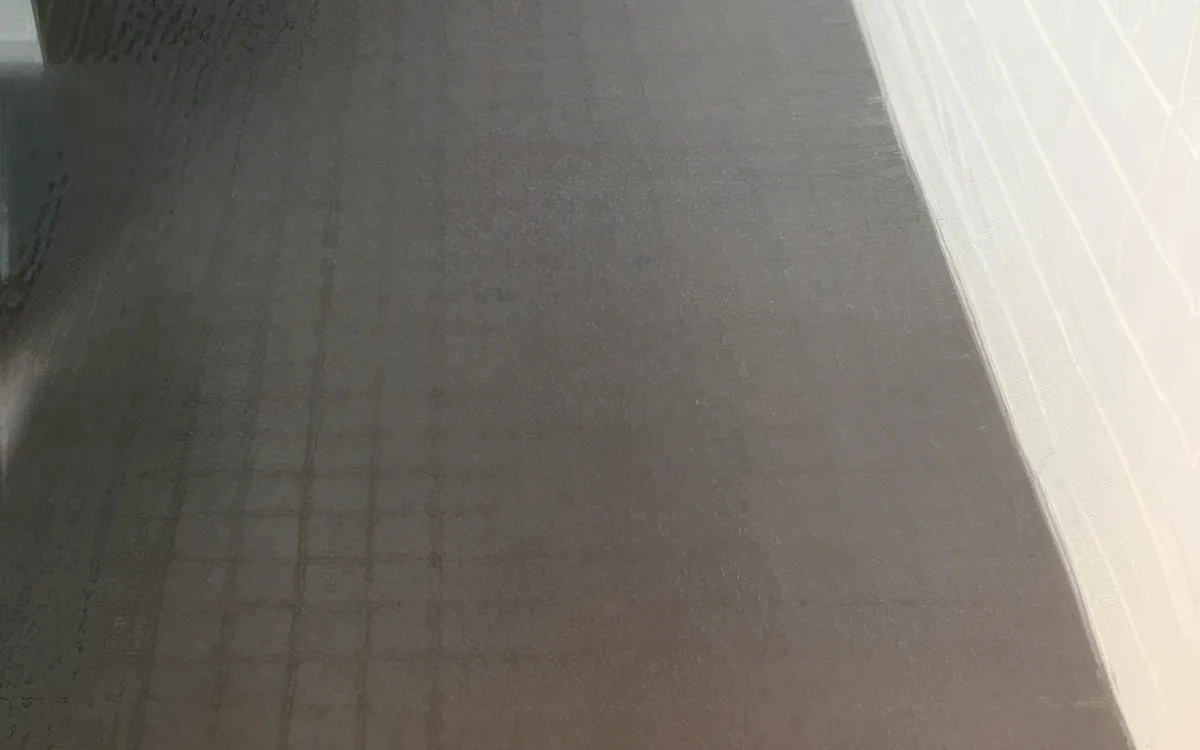 Dull, scuffed VCT hallway floor before restoration